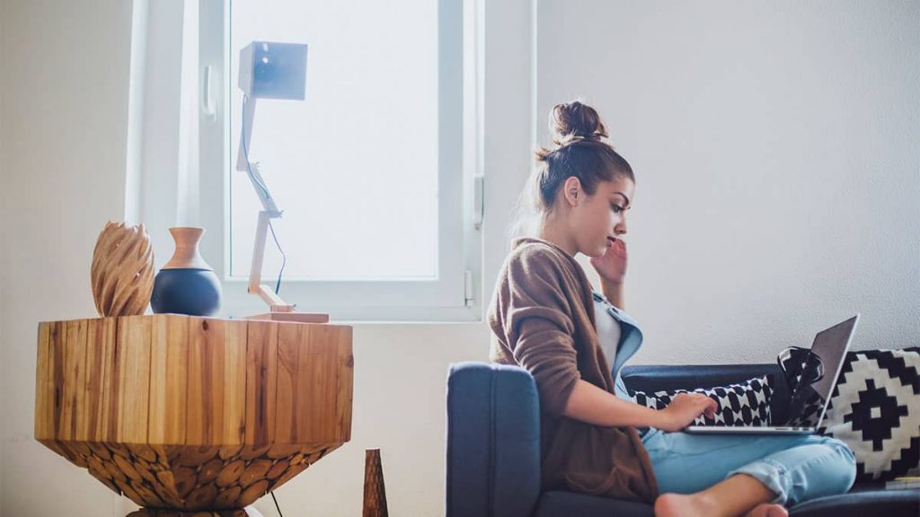 graduate application cover letter A young woman sat on her sofa looking at her laptop