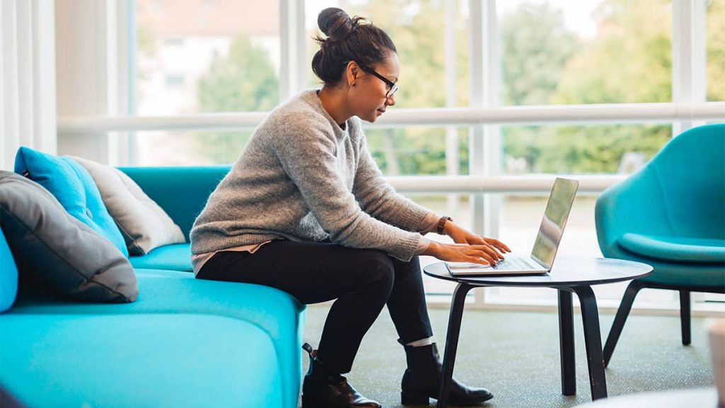 graduate application cover letter A young woman sitting on a chair typing on her laptop