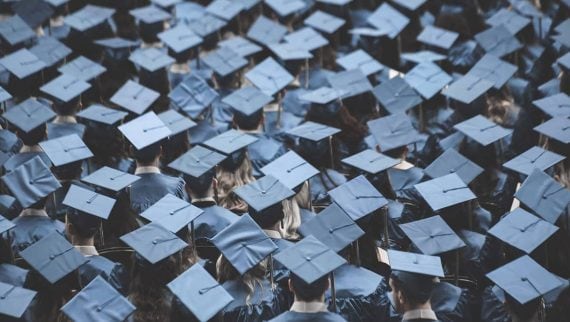 Lots of graduates stood together in their caps