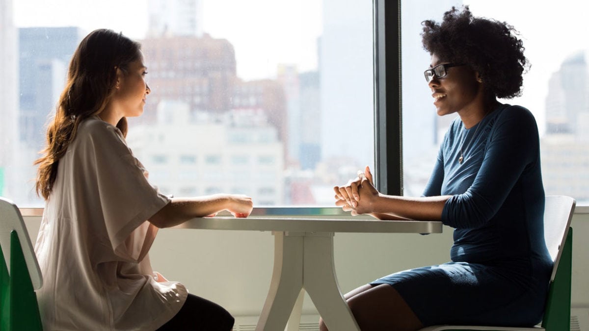 Image of two women having a meeting in a breakout space