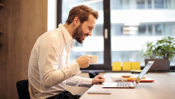 Man looking at laptop on a video call - as part of a reverse mentoring scheme