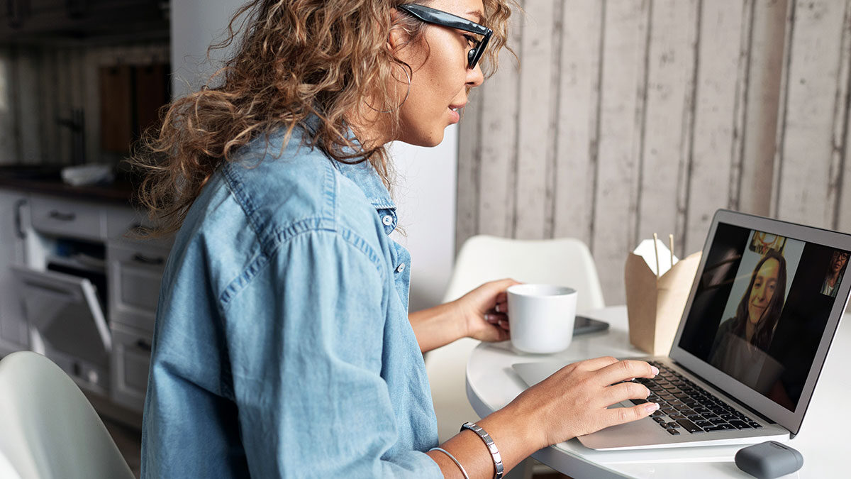 Image of a woman onboarding a new graduate via a video call