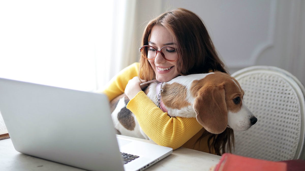 Women on a video call working from home with her dog